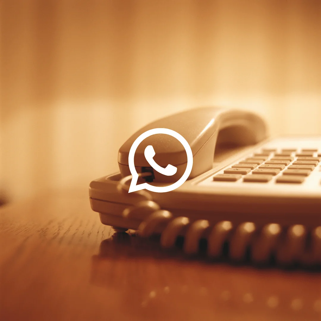 Smartphone showing a WhatsApp call screen with guidance about calling landline numbers